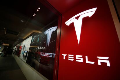 A sign bearing the Tesla company logo is displayed outside a Tesla store in Cherry Creek Mall in Denver, Colorado, Feb. 9, 2019.