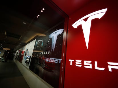 A sign bearing the Tesla company logo is displayed outside a Tesla store in Cherry Creek Mall in Denver, Colorado, Feb. 9, 2019.