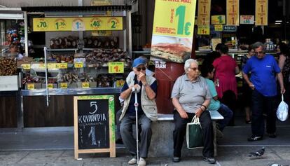 Viandantes junto a una tienda de Salónica. / SAKIS MITROLIDIS (AFP)