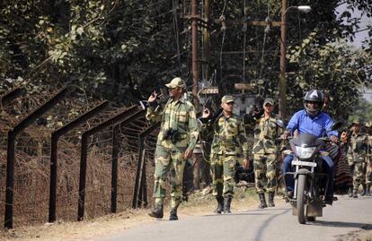 This photo taken on February 9, 2017 shows an Indian motorcyclist riding past Border Security Force (BSF) personnel taking part in a routine patrol near the India-Bangladesh border in the village of Lankamura, on the outskirts of Agartala. 
Built to keep out migrants, traffickers, or an enemy group, border walls have emerged as a one-size-fits-all response to the vulnerability felt by many societies in today's globalized world, says an expert on the phenomenon.
Practically non-existent at the end of World War II, by the time the Berlin Wall fell in 1989 the number of border walls across the globe had risen to 11.
That number has since jumped to 70, prompted by an increased sense of insecurity following the September 11, 2001 attacks in the United States and the 2011 Arab Spring, according to Elisabeth Vallet, director of the Observatory of Geopolitics at the University of Quebec in Montreal (UQAM).

This image is part of a photo package of 47 recent images to go with AFP story on walls, barriers and security fences around the world. More pictures available on afpforum.com / AFP PHOTO / Arindam DEY