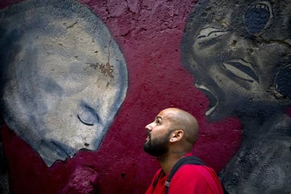 Yulier P. with one of his murals in February.