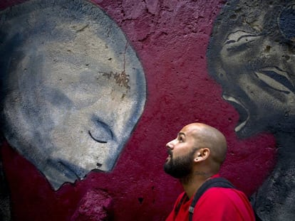 Yulier P. with one of his murals in February.