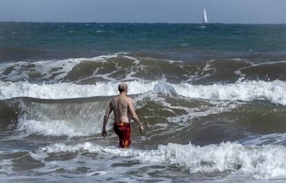 Un hombre se baña en la Playa de la Malvarrosa de Valencia, este martes. El calentamiento global se ha instalado en España y sus efectos se notan ya. Por ejemplo, el verano dura ahora casi cinco semanas más de media que a principios de los años ochenta.