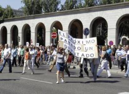 Funcionarios públicos que trabajan en Nuevos Ministerios, en Madrid, cortan el tráfico en el Paseo de la Castellana en protesta por los nuevos ajustes aprobados por el Gobierno.