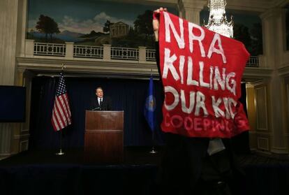 Un hombre protesta durante la rueda de prensa del vicepresidente de la NRA, Wayne Lapierre, en Washington.