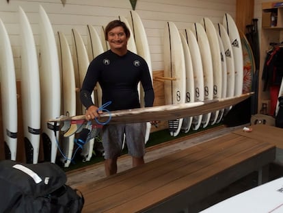 This May 19, 2019 photo provided by Dr. John Jones shows Mikala Jones at Surf Ranch in Lemoore, Calif., holding a surfboard his brother Daniel Jones made using material from the agave plant.