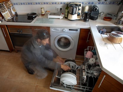 Un hombre recoge el lavavajillas.