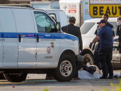 EDS NOTE: GRAPHIC CONTENT - A body is retrieved from a van by the Los Angeles County Coroner in Torrance Calif., Sunday, Jan. 22, 2023. A mass shooting took place at a dance club following a Lunar New Year celebration, setting off a manhunt for the suspect. (AP Photo/Damian Dovarganes)