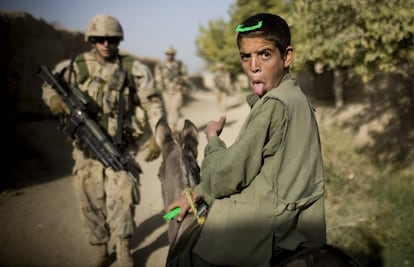 11 de septiembre de 2010. Un niño afgano en un burro gesticula ante los soldados canadienses de The Royal Canadian Regiment que patrullan en Salavat, al suroeste de Kandahar, Afganistán. Minutos más tarde, los soldados fueron atacados con granadas.