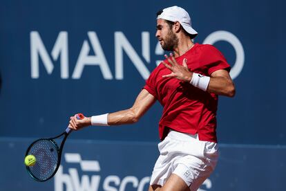 Khachanov hits the ball during the game.