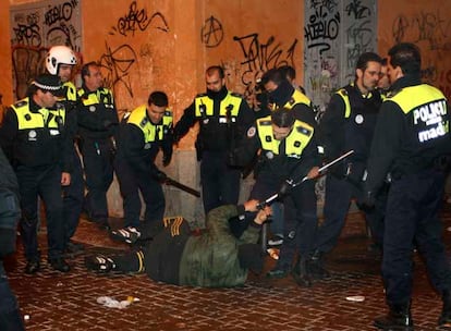 Un grupo de policas municipales rodea a un joven cado en el suelo, al que intenta quitar una muleta, en la confluencia de la calle de la Palma y Corredera Alta de San Pablo.