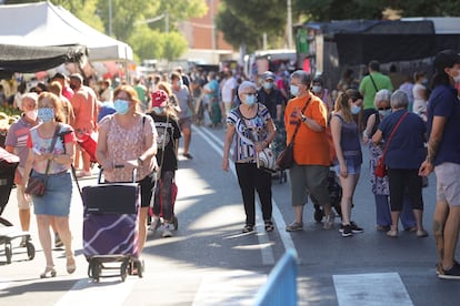 People wear face mask at an outdoor market in Fueblabrada in the Madrid region.