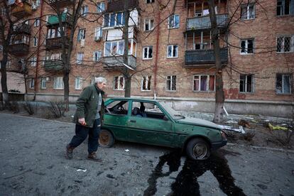 Un hombre pasa junto a un automóvil y un edificio dañado por un ataque militar en Kiev, la capital de Ucrania, este miércoles. Las fuerzas ucranias llevaron a cabo una serie de contraataques en los alrededores de la ciudad de Mikolaiv, al sur del país, y en las cercanías de Kiev, donde aseguran haber retomado el control de dos pequeñas poblaciones del noroeste de la capital. En Bucha, al noroeste de Kiev, se han observado atrincheramientos rusos. La inteligencia del Reino Unido asegura que las tropas de Putin están reorganizándose para acometer nuevas ofensivas a gran escala.