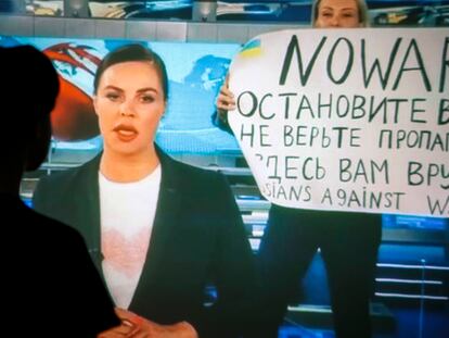 Una mujer ve la interrupción de la programación del primer canal de la televisión rusa por la editora de internacional, Marina Ovsianikova, con un cartel contra la guerra de Rusia contra Ucrania, este 15 de marzo.