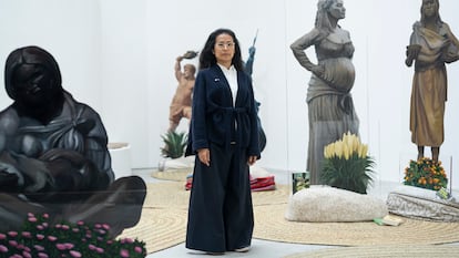 Artist Sandra Gamarra among the statues in her 'migrant garden' at the Spanish Pavilion at the Venice Biennale.