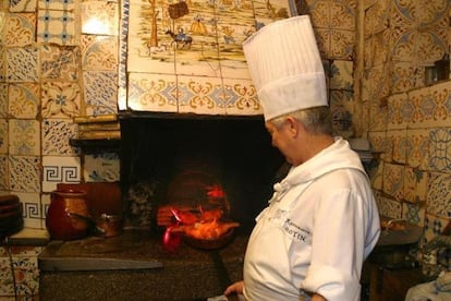Un cocinero del restaurante Botín asa cochinillo en el horno que lleva casi 300 años encendido.