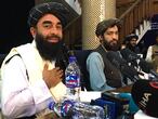 Taliban spokesperson Zabihullah Mujahid (L) attends the first press conference in Kabul on August 17, 2021, following their stunning takeover of Afghanistan. (Photo by Hoshang HASHIMI / AFP)