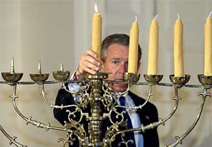 Bush enciende el Menorá durante la ceremonia que marca el inicio de la festividad judía de Hanuká.