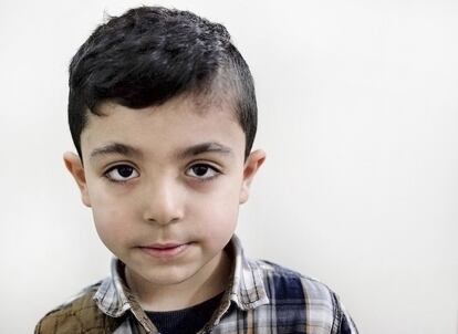 In this Feb. 13, 2016 photo, five year-old Hamza Ali, who fled with his family from Aleppo, Syria 3 years ago, poses for a portrait in Istanbul, Turkey. Mustafa Ali often tells his children about the beauty of the land they left behind. He was a primary school teacher and a sports trainer in Aleppo until he had to flee three years ago with his wife Suzan, 25, and his two children Sedra, 8, and Hamza, 5. His youngest daughter, Hulya, 2, was born in their adopted city, Istanbul, Turkey. (AP Photo/Bram Janssen)