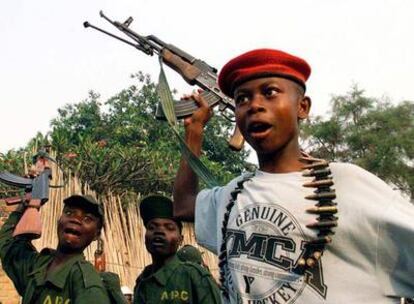 Unos niños soldado corean canciones de liberación y muestran sus armas en la base militar de Buina (Congo).