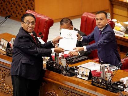 Dos parlamentarios indonesios muestran el informe sobre el nuevo código penal, durante una sesión plenaria parlamentaria celebrada este 6 de diciembre en Yakarta, Indonesia.