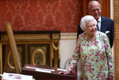 La reina Isabel II y el duque de Edimburgo, en la exhibición de la colección de objetos españoles en el palacio de Buckingham.