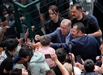 Turkey's President Recep Tayyip Erdogan with supporters at a polling station, in Istanbul, Turkey, Sunday, May 14, 2023.