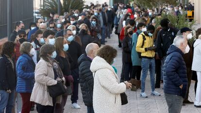 People line up outside a mobile vaccination center in Valencia.