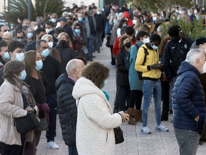 People line up outside a mobile vaccination center in Valencia.