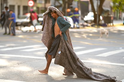 FILE - A homeless man crosses a street in an area occupied by drug users known as Crackland, in downtown São Paulo, Brazil, May 11, 2023.