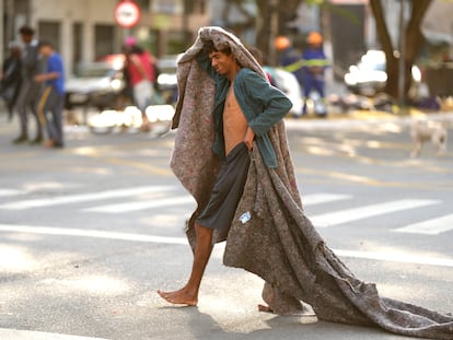 FILE - A homeless man crosses a street in an area occupied by drug users known as Crackland, in downtown São Paulo, Brazil, May 11, 2023.
