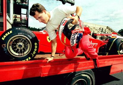 Schumacher salta del camión en el que está subido su coche, que tuvo que ser remolcado tras tener un problema en los entrenamientos oficiales del Gran Premio de Bélgica en 1997.