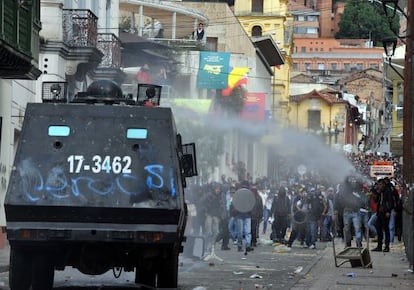 Riot police tanks try to disperse protesters with a water cannon during clashes which erupted after a march in support of Colombian farmers protesting in demand of government subsidies and greater access to land, in Bogota on August 29.