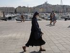 FILE PHOTO: A nun wearing a protective face mask walks at the Old Port (Vieux Port) in Marseille, France, September 17, 2020. REUTERS/Eric Gaillard/File Photo