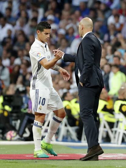 El delantero colombiano del Real Madrid, James Rodriguez (i), se saluda con el técnico francés del equipo blanco, Zinedine Zidane, tras ser sustituido.