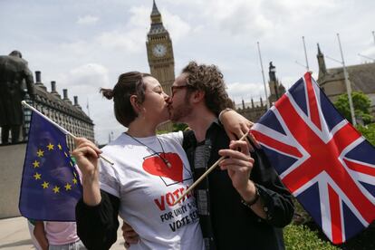 Una pareja posa besándose con banderas de la UE y Reino Unido durante una cadena de besos organizada en la Plaza del Parlamento en Londres.