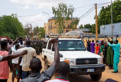 Protesters cheers for security forces on the sidelines of a protest in Niamey, Niger, on July 30, 2023.