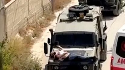 Israeli army straps Palestinian on military jeep during raid in Jenin, in this screengrab from a video, in the Israeli-occupied West Bank, June 22, 2024. REUTERS/Reuters TV