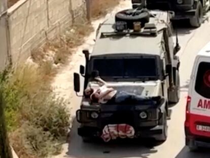 Israeli army straps Palestinian on military jeep during raid in Jenin, in this screengrab from a video, in the Israeli-occupied West Bank, June 22, 2024. REUTERS/Reuters TV