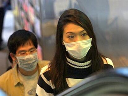 Transeúntes en Hong Kong (China) con mascarillas, ayer, para prevenir un eventual contagio de neumonía.