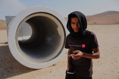 A resident of Al Bat next to a concrete pipe that has been supplied as a bomb shelter after a Hamas rocket killed four children in the village on October 7.  