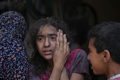 Una joven palestina herida en un ataque israelí es atendida por sus familiares en el campo de refugiados de Nuseirat, en el centro de Gaza.