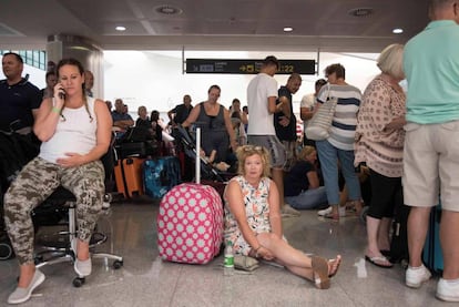 Thomas Cook passengers wait in Menorca airport.