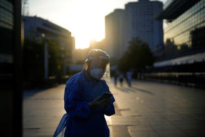 Una mujer con un traje protector caminaba este martes cerca de la estación de tren de Shangái (China), después de que se levantara el bloqueo que había sufrido la ciudad durante dos meses por un brote de covid.