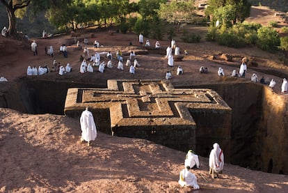 The exterior of Bet Giyorgis church surrounded by pilgrims.