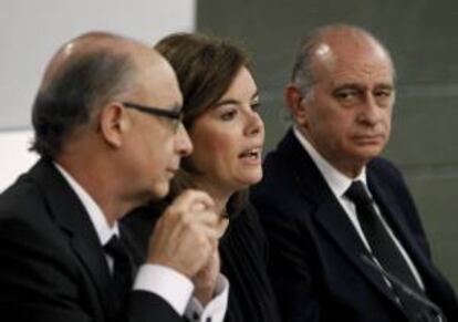 La vicepresidenta del Gobierno, Soraya Sáenz de Santamaría y los ministros de Hacienda, Cristóbal Montoro (i) e Interior, Jorge Fernández Díaz, durante la rueda de prensa posterior a la reunión del Consejo de Ministros que ha tenido lugar en La Moncloa. EFE/Archivo