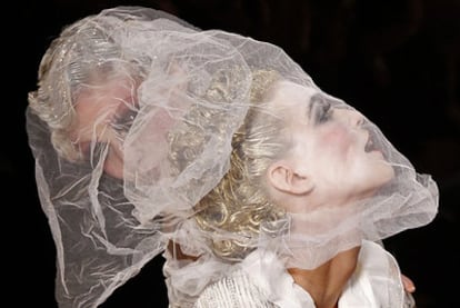 Dos modelos lucen las creaciones con transparencias de John Galliano.