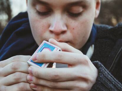 Un adolescente enciende un cigarrillo.