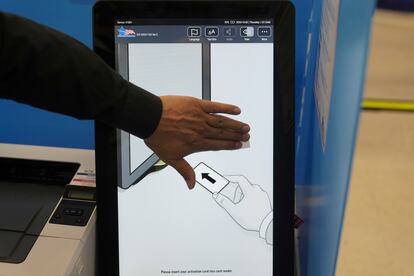 A worker cleans a machine screen during the first day of early voting on Oct. 3 in Chicago, Illinois.