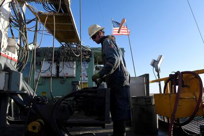 A worker operates equipment on a drilling rig near Midland, Texas, U.S.